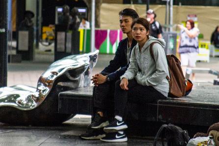 young couple sitting on the central stage in Canberra Walk